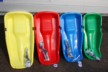 4 x plastic sledges (yellow, red, blue, green). File photo