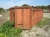 Åben affaldscontainer til wirehejs, ca 6 meter land, med 2 låger bagtil, noget medtaget 