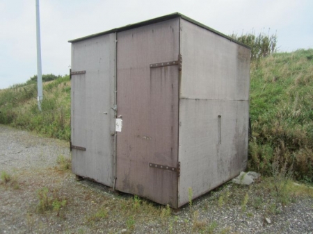Metal shed with brown wooden boards and roofing felt, about 2,6x2,6x2,6 meters