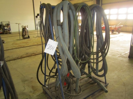 Pallet rack and suction hoses, pneumatic hoses, compressed air filter on a tripod etc.