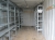 20' shipping container No. EMCU298315, fair condition / good, with light and 8 span storage shelves in metal, good quality, and installation. Pipes and Drums on the side