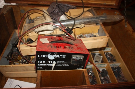 Box with various electrical parts, including 12 volt charger, coal for electric motors, etc.