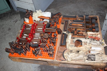 Pallet with various tools to lower the spark machine
