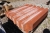 Pallet with about 22 x roof tiles, brick-red, cut corners, holes