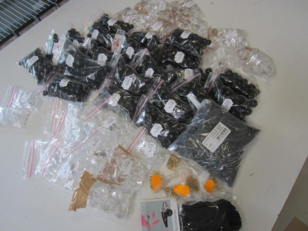 Approximately 45 bags of wax beads, prisms and the like glassware, glass beads, leather lace, pins