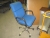 Office chair with blue upholstery and 2 waste racks on wheels