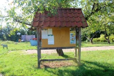 Information board with tiled roof
