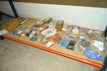 Content on the bottom shelf of the pallet rack: various electronics components