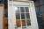 Front door with sidelight, wood, white. Bar windows with frosted glass. Frame dimensions approximately 149 x 247 cm