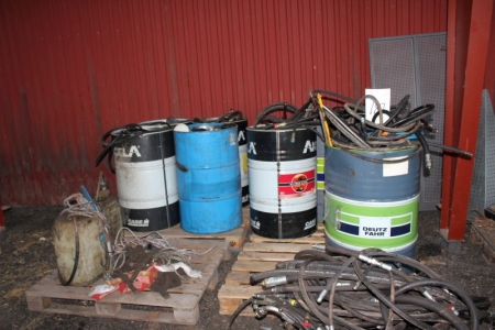 Miscellaneous barrels with hydraulic hoses, etc.