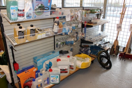 Content on the shelf various accessories for pressure washers, hoses + detergent, etc.