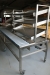 Stainless steel packaging table with roller conveyor, 2 varmekar and 6 adjustable trays goal 260x97xh82 / 92 cm, height electro-hydraulic adjustable. At 6 swivel lockable wheels. Roller conveyor with end stop, width 30 cm. 2 varmekar with adjustable heat 