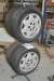 4 x winter tires on rims, 185/65 R14. 5. Hardly used. Good pattern. 5 hole rims + hubcaps + stand