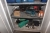 Steel cabinet containing various hand tools + electric tool + fittings + couplings etc.