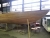 Wooden sailboat under construction. Drawn by Jørgen Roos, Lynæs. Length = 47 feet. Width = 3.8 m. Cladding: mahogany on laminated oak tree. Complete ship deck included (has been loosely fitted). Beams in glossy lacquered oak. Cover painted white on the un