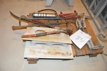 Pallet with various, including stone clamps, bolt cutters, crowbars, grease gun, steel trowels