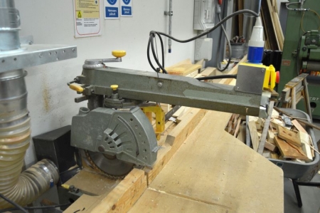 Radial saw. Attached emergency stop. Unknown make and type. Homemade table with inlet and outlet