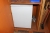 Wooden cupboard with content, refrigerator, chairs table, coffee machines
