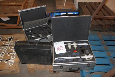 Pallet with plastic and aluminum suitcases, some containing various demo products