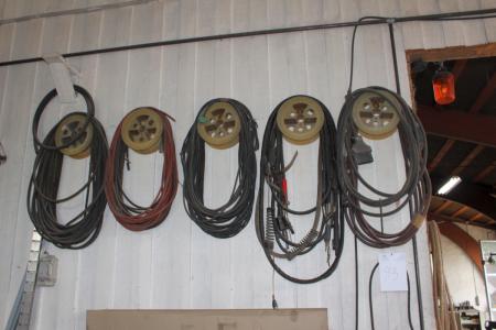 Hoses and welding cable on wall