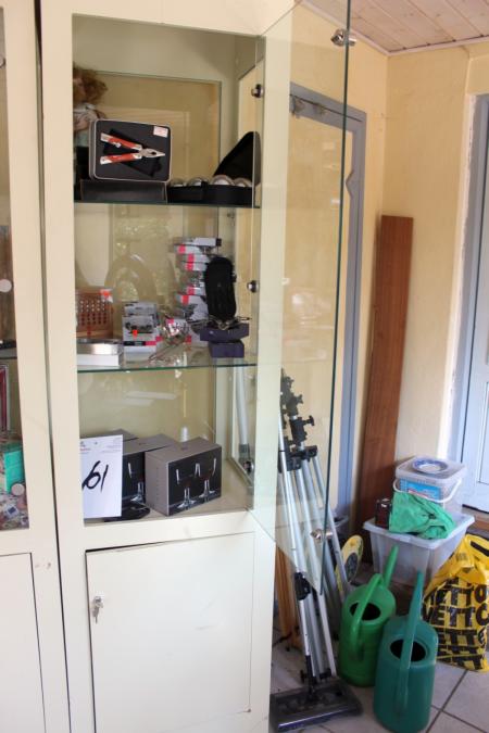 Cabinet with glass door containing multi tool + earphones + hits + knives + Rosendahl wine glasses, etc.