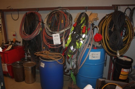 Clamp rack with oxygene and acetylene hoses + welding cables, power cables and more + barrel with anti freeze solution + oils