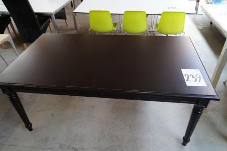 Black dining table with carvings on the legs. L 180 x B 100 cm