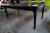 Black dining table with carvings on the legs. L 180 x B 100 cm