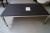 Sofabord, sort MDF plade, chrom stel. L 140 x B 80 cm. Der er slået skal af kant.