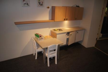 Children's Corner of three base cabinets with a lowered side table.