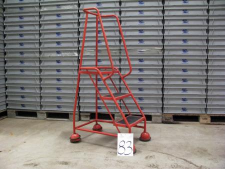 Platform ladder. Red on wheels. Height to the platform about 80 cm.
