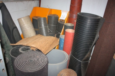 Large quantity of linoleum carpets and other capets behind carpet decoiler