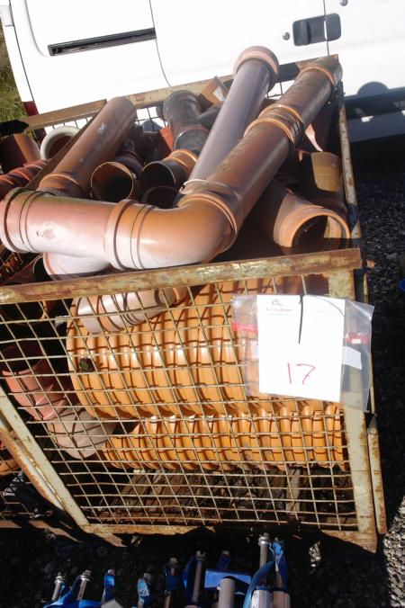 A steel cage with various plastic pipes