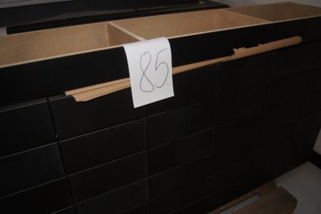 Disk in black with 36 small drawers with push pull. L = 180 cm. D = 43 cm. (Incl.skuffe). H = 97 cm. (Incl.sokkel).