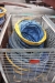 (4) wire cages and (1) pallet with flexible hoses