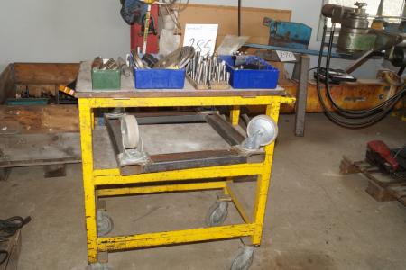 Steel rolling table with various tool holders and machine parts