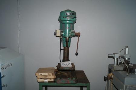 Bench drill on steel table