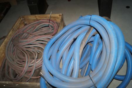 Pile with flex pipe and long length oxygen and gas hose.