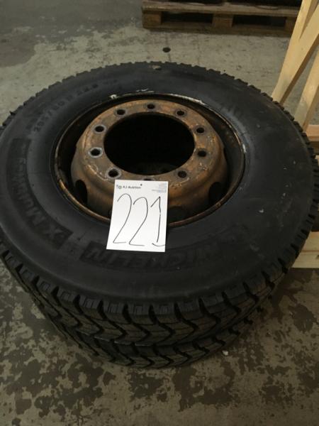 2 pieces of car tire with rims almost 100 pct track.