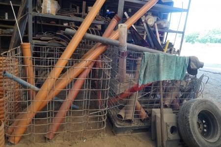 2 cages with various sewer pipes and fittings.