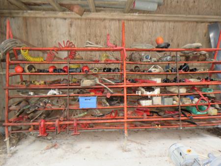Shelf containing various PTO parts, chains, tools, and more