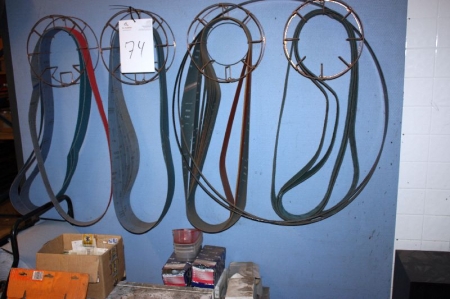 Various grinding belts on wall + boxes with grinding belts and screws on floor