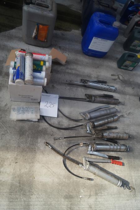 Various grease syringes including new nipples and grease cartridges.