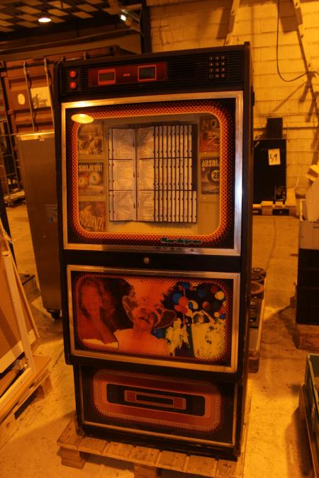 Juke box, made in Leeds, with English pound coin dump. Built-in speakers.