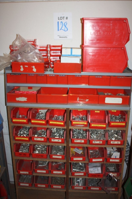 Assortment rack with content on wall. Parts for cable connectors