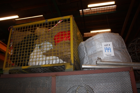 Pallet with (5) rope coils + (1) rope coil + cage pallet containing table cloths and the Danish flag. Located on steel rack