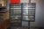 (6) section steel rack with content: electrical parts, flash lights, (3) band saw blades labelled (3160x27x0,9mm, 8/12 TPI) + assortment rack on wall + power cables
