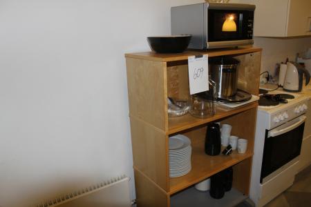 3 shelving with content as well as microwave