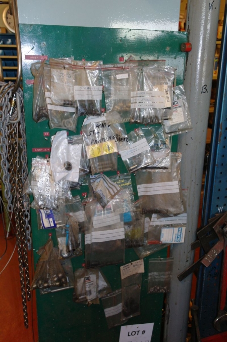 Various gaskets and more on wall + bucket with tools on floor