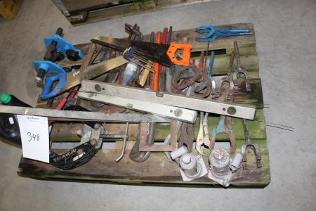 Palle with various hand tools, welding rods, running cat and more.